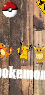 Pokemon wallpaper with Pikachu, Charmander, and Eevee on wooden background.