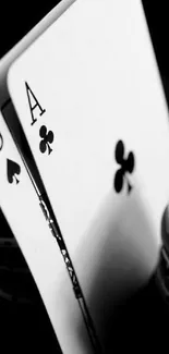 Black and white poker cards with chips in focus.