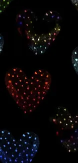 Colorful polka dot hearts on black background wallpaper.