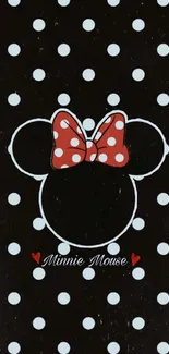 Minnie Mouse silhouette with red polka dot bow on black background.