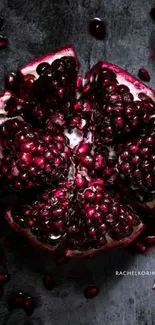 Close-up of a pomegranate with dark red seeds and a textured background.