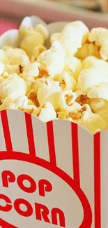 A bright box of popcorn with red stripes.