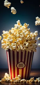 Popcorn bursting from a striped box against a dark background.