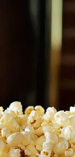 Close-up of buttery popcorn on a dark background.