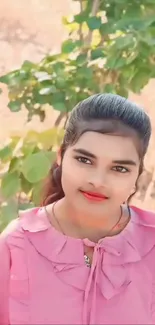 Young woman in pink dress with natural green background