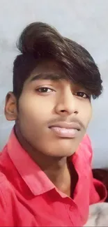 Portrait of a young man in a red shirt.