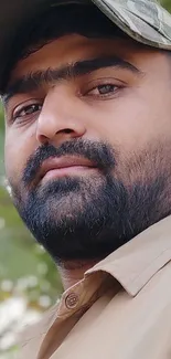 Bearded man in camouflage hat portrait.