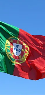 Portuguese flag against a blue sky, ideal for mobile wallpaper.