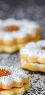 Close-up of powdered sugar cookies with orange filling.