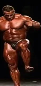 Muscular bodybuilder posing on stage with dark background.