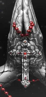 Praying hands with cross and beads on dark background.