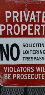 Red private property sign with warning text.