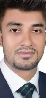 Professional portrait of a man in a suit with a white background.