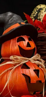 Halloween pumpkin stack with witch hat in autumn decor.