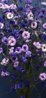 Beautiful purple and blue flower arrangement on a blue background.