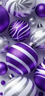 Purple and silver Christmas ornaments with festive design.