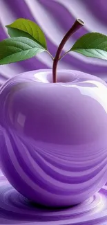 Purple apple with green leaves on a textured background.