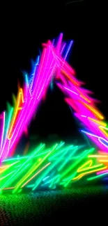 Vibrant neon triangle with colorful light streaks on a black background.