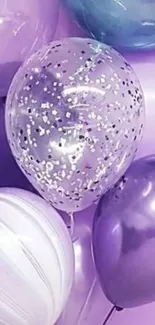 Purple and silver balloons with glitter accents on a soft background.