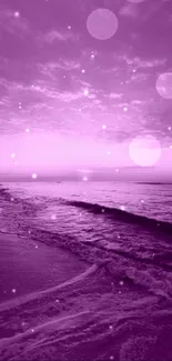 Purple sunset over beach with waves crashing.