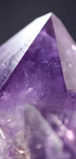 Close-up of a sharp purple crystal with textured amethyst hues.