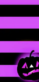 Purple and black striped wallpaper with a glowing Halloween pumpkin.