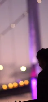 Silhouette against a purple cityscape with glowing bokeh lights.