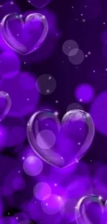 Purple heart wallpaper with glowing bokeh effects in vibrant shades of purple.