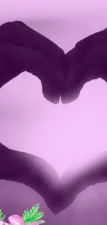 A heart-shaped hand silhouette on a purple background with floral accents.