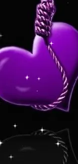 Vibrant purple heart hanging on a dark background wallpaper.