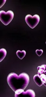 Mobile wallpaper with floating purple hearts on black background.