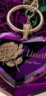Purple heart keychain with rose engraving and gold accents.