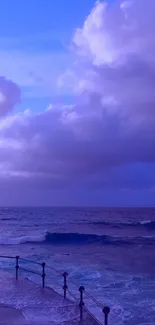 Purple ocean under expansive cloudy sky.