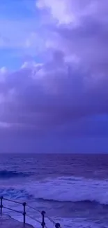 Purple ocean waves with cloudy dusk sky.