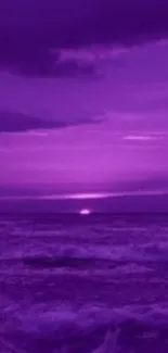 Purple sunset over ocean with calm waves.