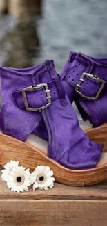 Purple sandals on wooden surface beside white flowers.