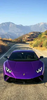 Purple sports car on scenic mountain road under blue sky.