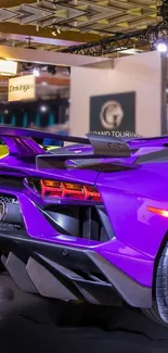 Vibrant purple sports car at an auto show.