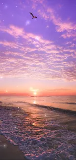 Purple sunset over ocean with beach and bird in the sky.