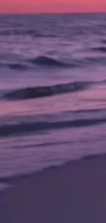 Purple sunset over beach waves wallpaper.