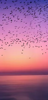 A serene sunset with birds against a purple and pink sky, perfect for mobile wallpaper.