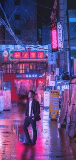 Man stands in neon-lit city street at night.