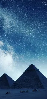 Pyramids illuminated under a starry night sky, creating a breathtaking view.