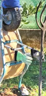 Wheelbarrow sculpture with sunglasses made of garden tools.