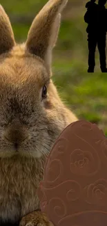 Bunny and chocolate egg on green field wallpaper.