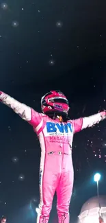 Racer in a pink suit celebrating under starry sky.