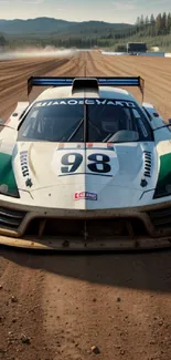 Racing car on a dirt track with a forest background and mountains in view.