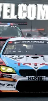 Dynamic car race with welcome sign in foggy track scenery.