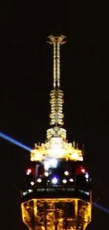 Eiffel Tower brilliantly lit at night against dark sky.