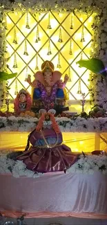 Vibrant Ganesha shrine with flowers and lights.